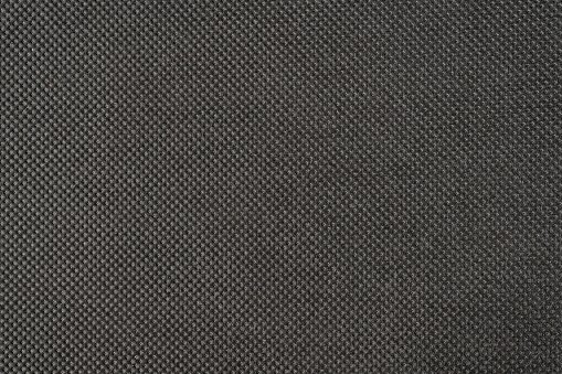 black non woven fabric extremal close up. texture and background